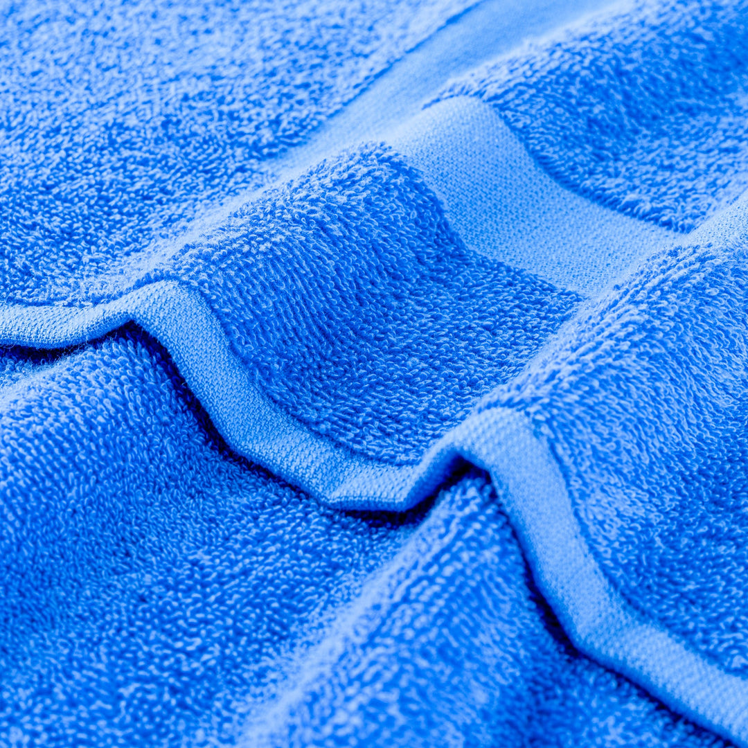 Blue terry gym towel with textured loop fabric and stitched edge close-up