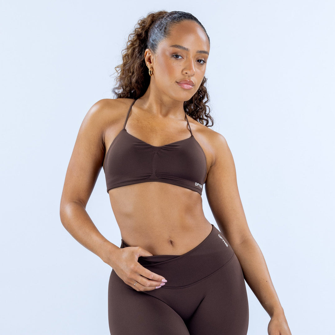 Dark brown sports bra with thin straps and front logo