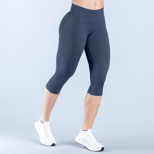 Dark navy mid-calf leggings with straight waistband and smooth stretch fit